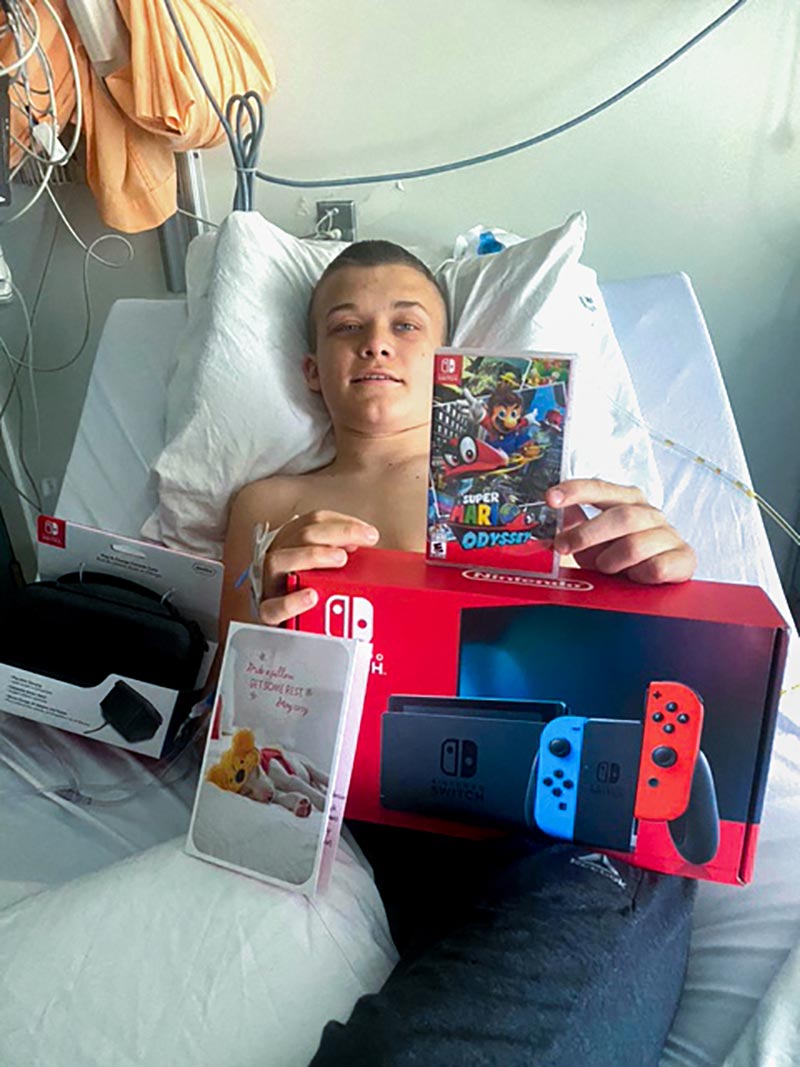 boy in hospital bed with games